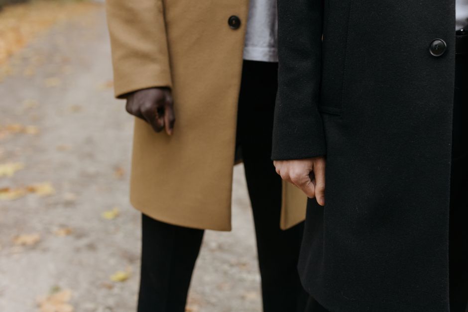 Close-up of two men wearing fashionable coats outdoors on an autumn day.
