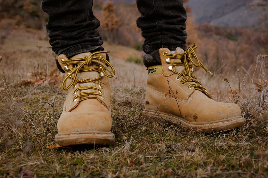 Sturdy hiking boots on rugged mountain terrain, perfect for outdoor adventures.
